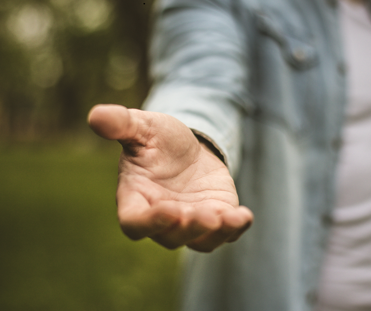 An open hand reaching out in invitation